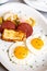 Close-up photograph of a traditional Dominican Mangu breakfast, featuring fried eggs