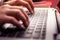 Close up photography of female hands typing on the laptop keyboard. Concept teleworking at home