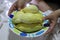 Close-up photos of Asian women  Holding a plate of yellow durian, the most popular fruit of Thailand in the appetizing dish