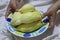 Close-up photos of Asian women  Holding a plate of yellow durian, the most popular fruit of Thailand in the appetizing dish