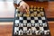 Close-up photos of checkmate hands on a chessboard during a chess game The concept of business victory strategy wins the intellige