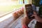 Close-up photos of women holding a smartphone, taking a photo of a coffee mug in a coffee shop, relaxing mood