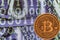 Close up physical bitcoin coin with dollars and matrix codes background