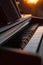 Close-up of a piano with music sheets on it during golden hour