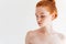 Close up picture of attractive naked ginger woman looking away