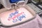 Close up picture of embroidery machine embroidering text on towel