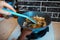 Close-up picture of female hand, stirring fried chopped onions on the pan, in the kitchen area