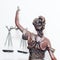 Close up picture of lady justice or themis goddess standing back holding scales blindfold on white background