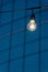 Close up picture of light bulb against Building window background.