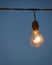 Close up picture of light bulb against Building window background.