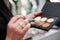 Close-up picture of make-up tools in female hands in beauty salon. Professional eye shadow palette in brown shades for work of