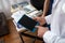 Close up picture of mans hands holding a tablet