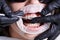 Close-up picture of mouth during dental procedure of removing rubber bands from brackets