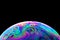 Close up picture of soap bubble on black background like planet abstract multicolor psychedelic globe