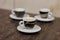 Close up picture of three little cups and saucers, with coffee espresso, with tiger pattern design, on marble background.