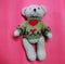 Close-up picture, top view, cute teddy bear  Wearing a winter coat  Separate single, dark pink background