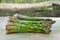 Close up Picture of two bunches of freshly harvested spring green asparagus stalks.