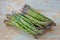 Close up Picture of two bunches of freshly harvested spring green asparagus stalks.