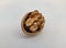 Close up picture of the walnut with it`s one side shell on white background.