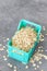 Close up picture of whole grain oats in miniature container, selective focus