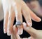 A close-up picture of a woman wearing beautiful ring jewelry on her finger.