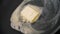 Close-up of piece of butter melting in frying pan. Action. Cooking dish in frying pan with melted piece of butter. Fat