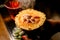 Close-up of piece of pineapple in woman's hand with steaming caramel crust on it