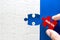 Close up piece of white jigsaw puzzle with Join Us text , concept of a business challenge success completion with teamwork