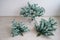 Close-up of pieces of artificial Christmas tree against a white wall. The process of mounting and decorating a tree for