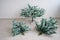 Close-up of pieces of artificial Christmas tree against a white wall. The process of mounting and decorating a tree for