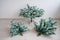 Close-up of pieces of artificial Christmas tree against a white wall. The process of mounting and decorating a tree for