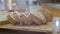 Close-up of pieces of fresh baked steaming from the oven Dutch raisin bread lying on the wooden cutting board