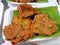 Close up of pieces of Thai fish cake Tod Mun Pla on a Banana leaf for sale at a local market in Thailand