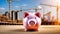 Close up of a piggy bank on sunny construction site. Savings deposits for the building phase