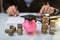 Close-up Of Piggy Bank Wearing Graduation Hat And Stacked Coins