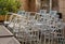 Close-up on a pile of aluminum chairs. Pile of chairs at the backyard of a street cafe