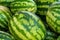 Close up of a pile of beautiful delicious green watermelons on t