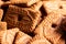 A close up of a pile of brown cookies called speculoos or speculaas in Belgium or the Netherlangs. The spiced biscuit is very