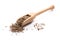 Close-up of pile of cumin seeds spice in a wooden spoon on white