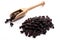 Close-up of pile dried, raw black currant in a wooden spoon on