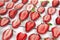 Close-up pile of fresh chopped strawberries on white background. Heap, many of organic ripe sliced strawberry