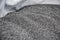 Close up of a pile of fresh harvested poppy seeds spread in bowl, ready for drying, macro photo. Ingredient for baking