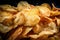 close-up of a pile of freshly fried potato chips, golden and crispy