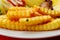 Close up of a pile of golden French fries on a plate