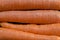 Close-up of a pile of orange carrots in a market