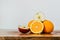 Close-up of a pile of oranges and apples on a wooden