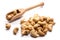 Close-up of pile of roasted, salted cashew nuts in a wooden spoon on white background