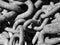 Close up of a pile of rusty chain, black and white