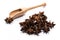Close-up of pile of Star anise spice in a wooden spoon on white