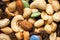 Close up of pile of trail mix with nuts, raisins, and candy